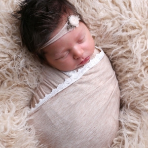 newborn-girl-wearing-taupe-wrap