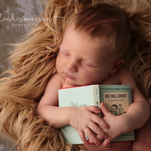 newborn-holding-book-prop-carmel-indiana
