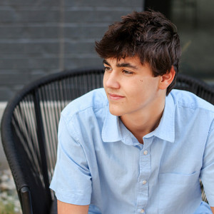 Boy poses for senior portraits in Carmel, Indiana