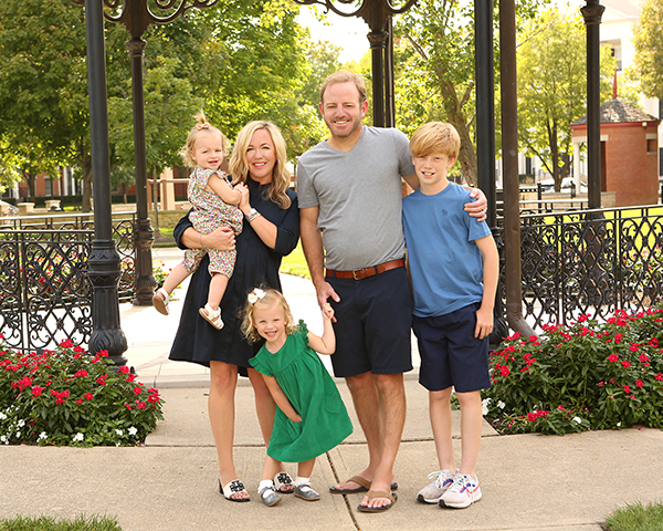 mom dad and three kids pose for family portrait in village of west clay