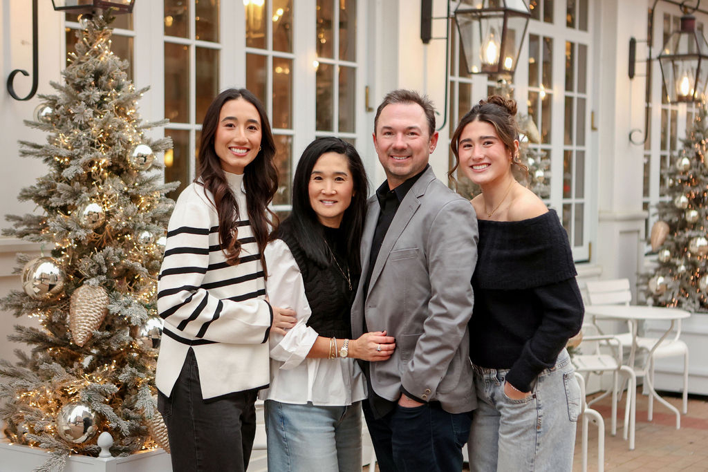 Family posing for Christmas portraits in carmel, Indiana