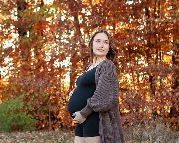 outdoor maternity photoshoot in the Fall with rich golden trees
