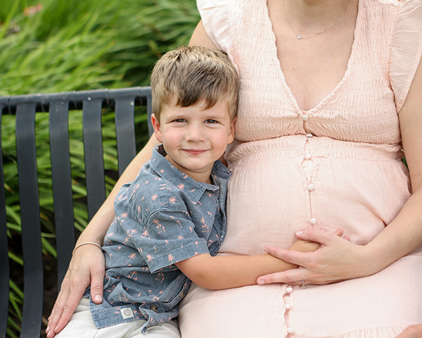 boy excited about baby sister's upcoming birth