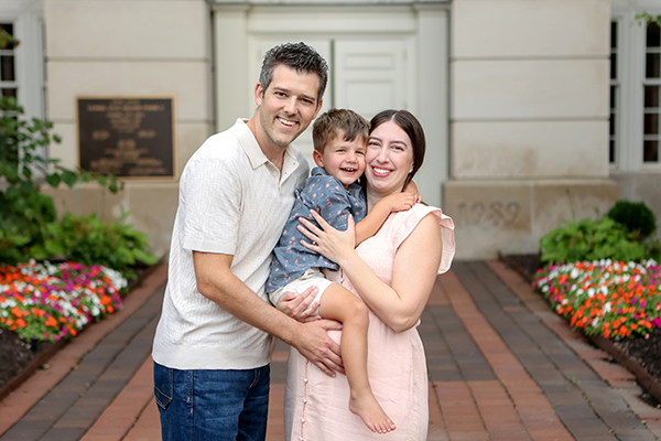 mom dad and son snuggle for photo