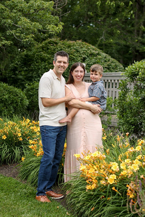 family poses in flowers 